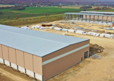 Aerial view of a large industrial construction site in a rural area with ongoing work