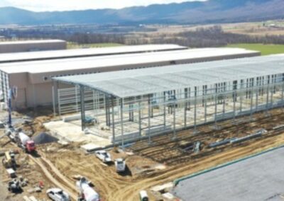 Aerial view of industrial construction site with unfinished buildings and equipment